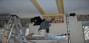 dave painting on scaffold
